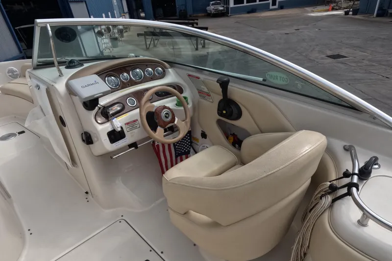 Slide: The Image of 2001 Sea Ray 240 Sundeck boat interior with steering wheel and dashboard. - 31