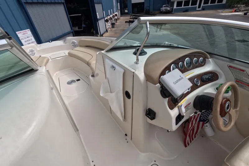 Slide: The Image of 2001 Sea Ray 240 Sundeck boat interior with Garmin navigation system and seating area. - 33