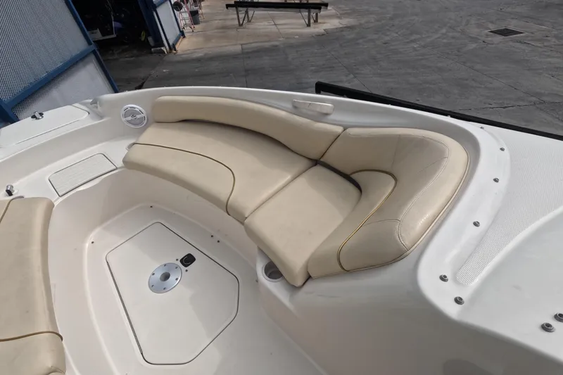 Slide: The Image of 2001 Sea Ray 240 Sundeck boat interior with beige seating and storage compartment. - 35