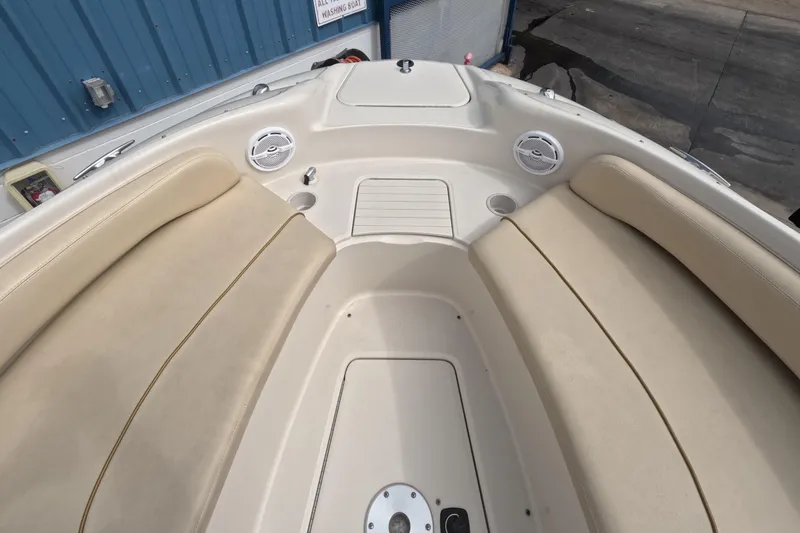 Slide: The Image of 2001 Sea Ray 240 Sundeck interior with beige seating and speakers. - 36