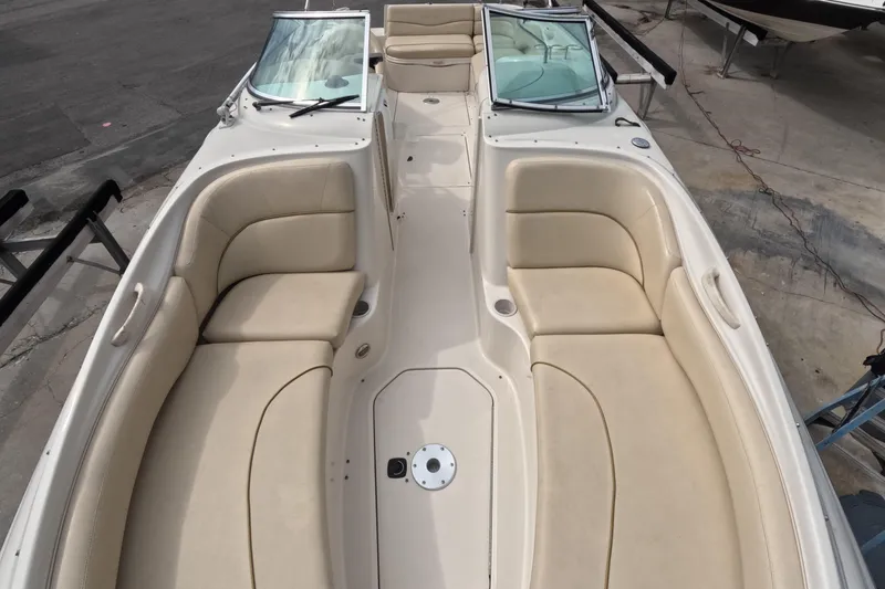 Slide: The Image of 2001 Sea Ray 240 Sundeck boat interior with beige seating and open deck layout. - 38
