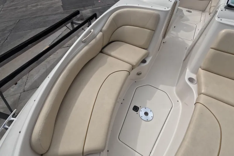 Slide: The Image of 2001 Sea Ray 240 Sundeck boat interior with beige seating and spacious layout. - 39