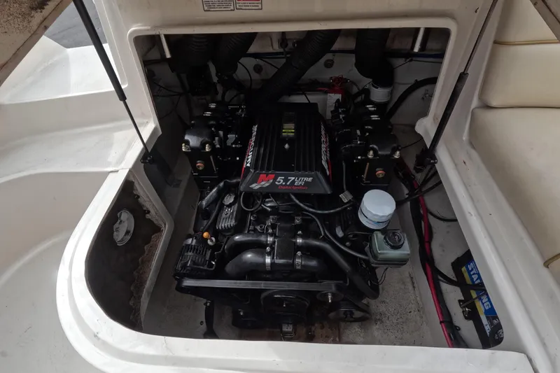 Slide: The Image of Engine compartment of a 2001 Sea Ray 240 Sundeck boat, featuring a 5.7L engine. - 4
