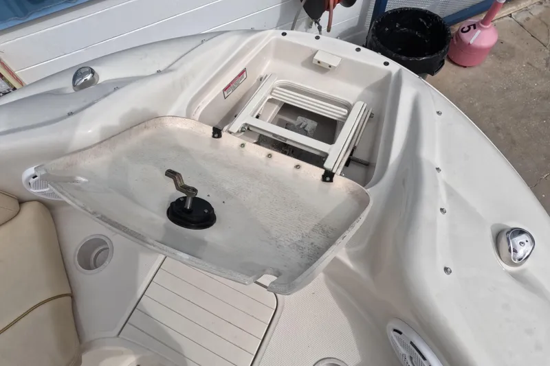 Slide: The Image of 2001 Sea Ray 240 Sundeck boat interior with open storage compartment and seating area. - 41