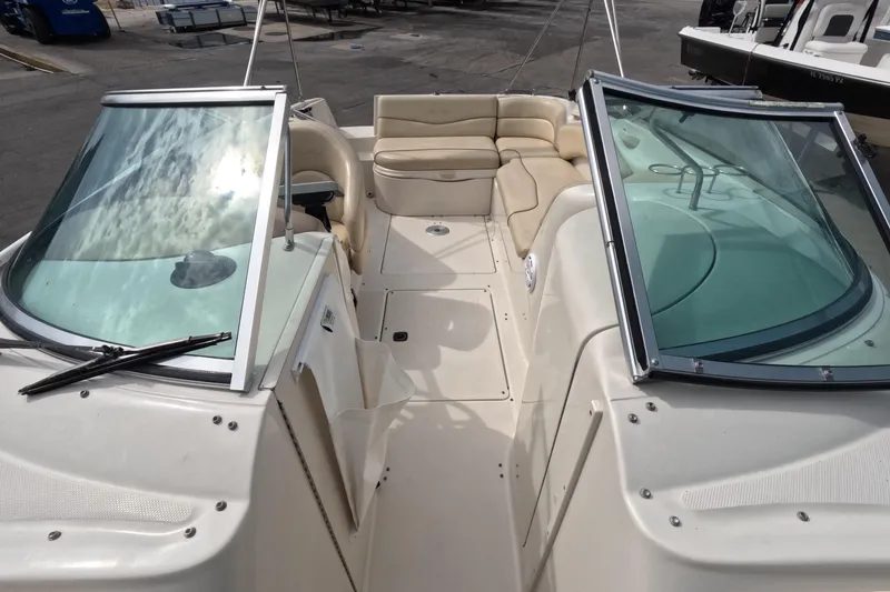 Slide: The Image of 2001 Sea Ray 240 Sundeck boat interior with seating and windshield. - 46