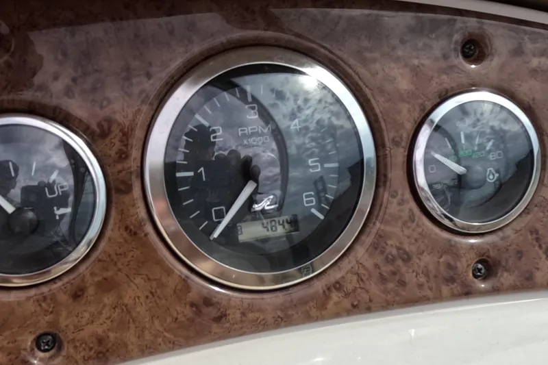 Slide: The Image of Dashboard of 2001 Sea Ray 240 Sundeck showing RPM and fuel gauges. - 5