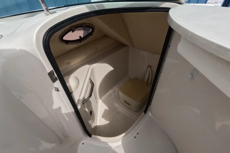 Slide: The Image of Interior view of 2001 Sea Ray 240 Sundeck boat's compact bathroom area. - 51