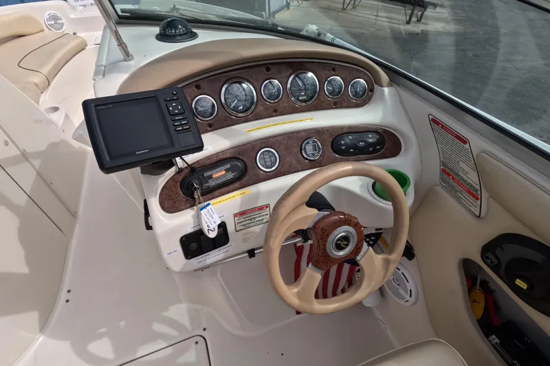 Slide: The Image of 2001 Sea Ray 240 Sundeck dashboard with steering wheel and navigation system. - 53