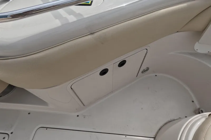 Slide: The Image of Interior view of a 2001 Sea Ray 240 Sundeck boat, featuring seating and storage compartments. - 56