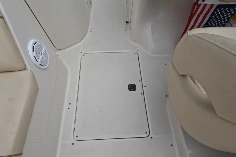 Slide: The Image of 2001 Sea Ray 240 Sundeck interior with seating, speaker, and American flag detail. - 59