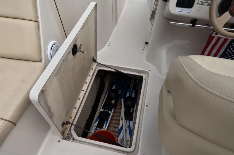 Slide: The Image of Storage compartment on 2001 Sea Ray 240 Sundeck with water skis and American flag. - 60