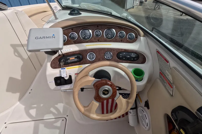 Slide: The Image of 2001 Sea Ray 240 Sundeck dashboard with Garmin GPS and steering wheel. - 7