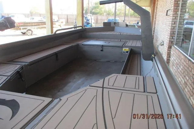 Slide: The Image of 2026 Reaper Boats 656-1830 MUD model, spacious interior view, docked in a covered area. - 2