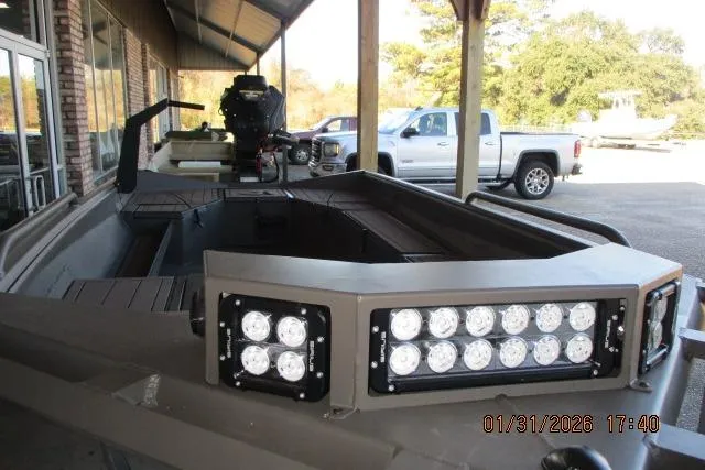 Slide: The Image of 2026 Reaper Boats 656-1830 MUD with LED lights, parked outdoors. - 5