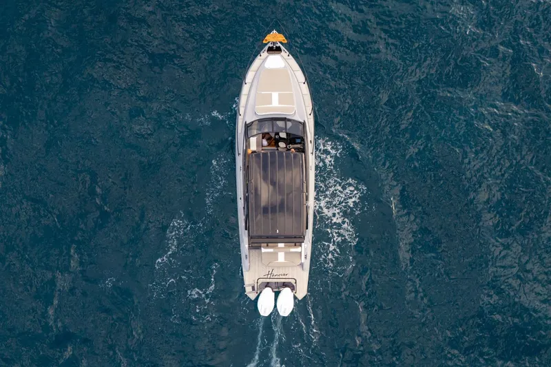 Slide: The Image of Aerial view of 2026 Hanover 305 boat cruising on open water. - 10
