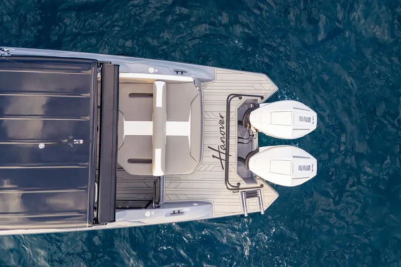 Slide: The Image of Top view of 2026 Hanover 305 boat with dual engines on blue water. - 13