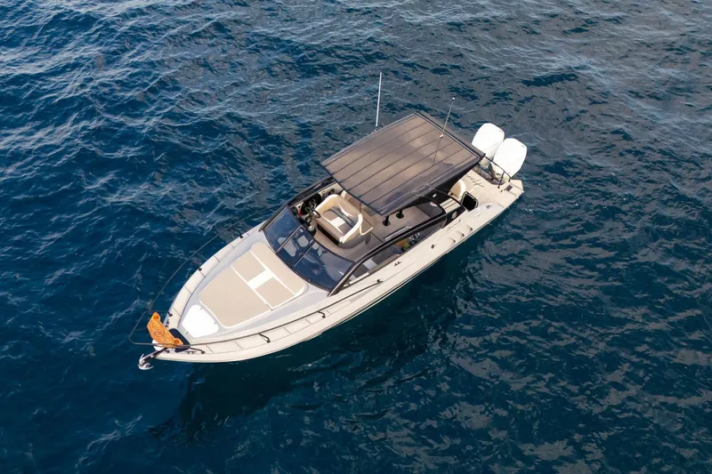 Slide: The Image of Aerial view of 2026 Hanover 305 boat cruising on open water. - 2