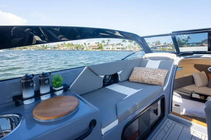 Slide: The Image of Luxurious Hanover 305 boat interior, 2026 model, featuring elegant seating and scenic waterfront view. - 24