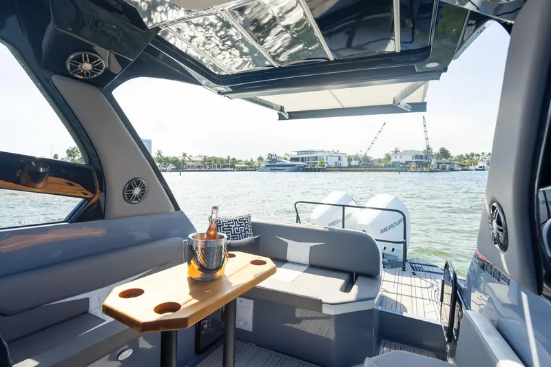 Slide: The Image of Luxurious 2026 Hanover 305 boat interior with seating, table, and scenic waterfront view. - 28