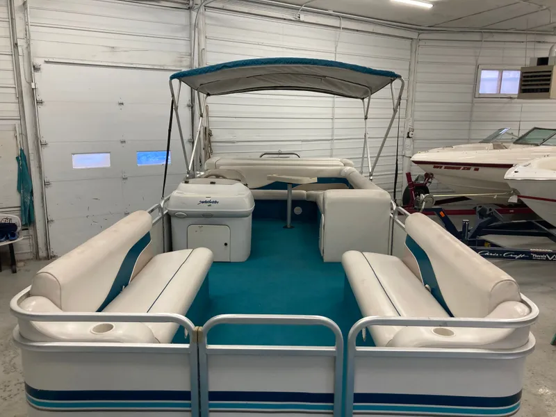 Slide: The Image of 2000 Godfrey Sweetwater 24ELITE pontoon boat in a garage. - 12