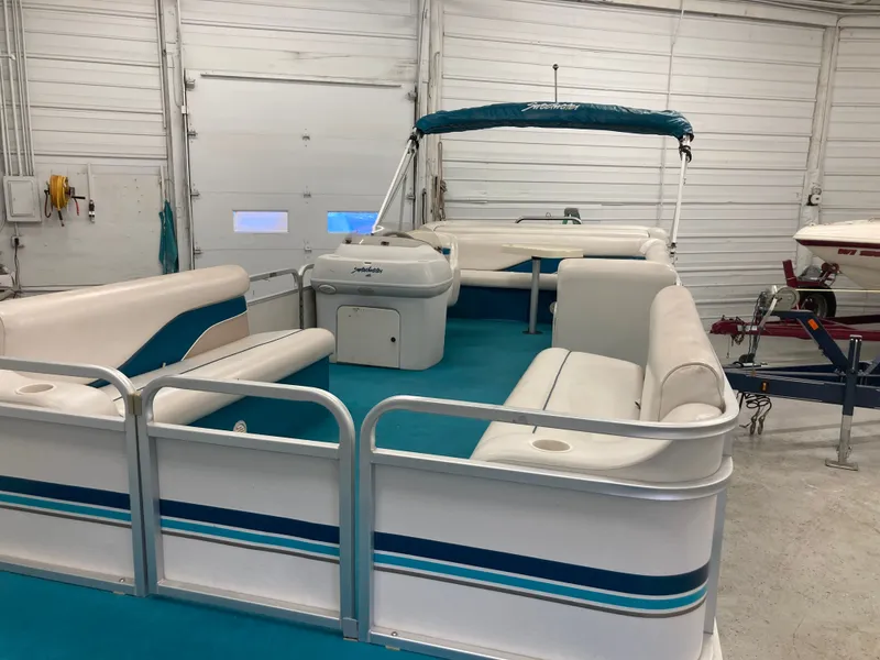 Slide: The Image of 2000 Godfrey Sweetwater 24ELITE pontoon boat in a garage. - 13