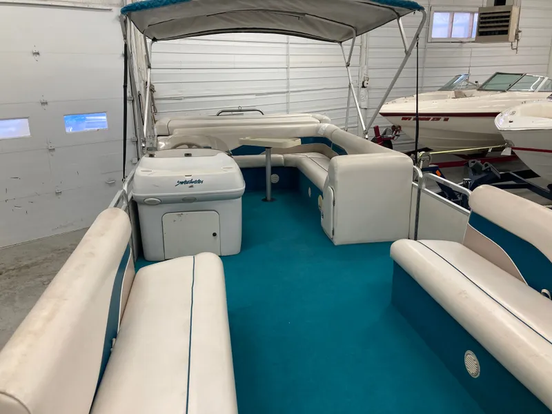 Slide: The Image of Interior of a 2000 Godfrey Sweetwater 24ELITE pontoon boat in a garage. - 14