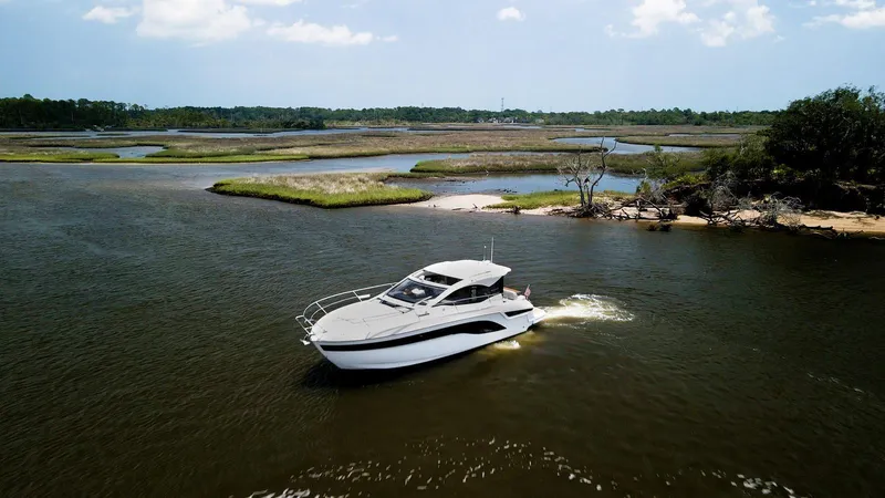 The Image of 2022 Bavaria SR41 yacht cruising in a scenic, tranquil waterway. - 0