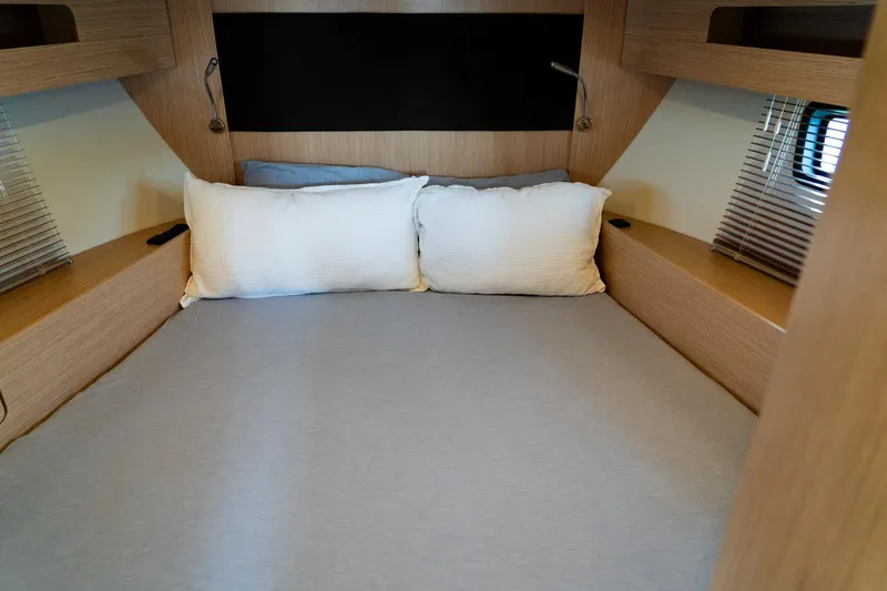 Slide: The Image of Cozy cabin bed in 2022 Bavaria SR41 yacht with wooden accents and soft pillows. - 13