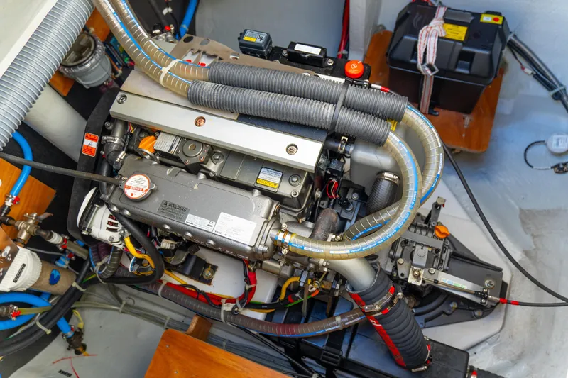 Slide: The Image of Engine compartment of 2023 Lagoon 46 yacht, showcasing detailed mechanical components and wiring. - 100