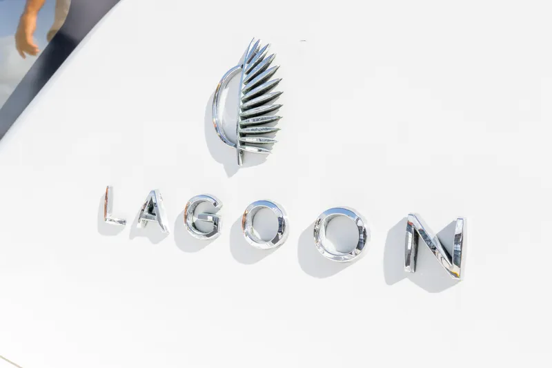 Slide: The Image of 2023 Lagoon 46 yacht logo with sleek chrome lettering and emblem. - 101