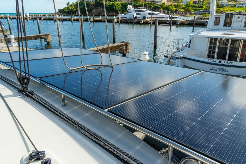 Slide: The Image of 2023 Lagoon 46 yacht with solar panels docked at marina, sunny day. - 106