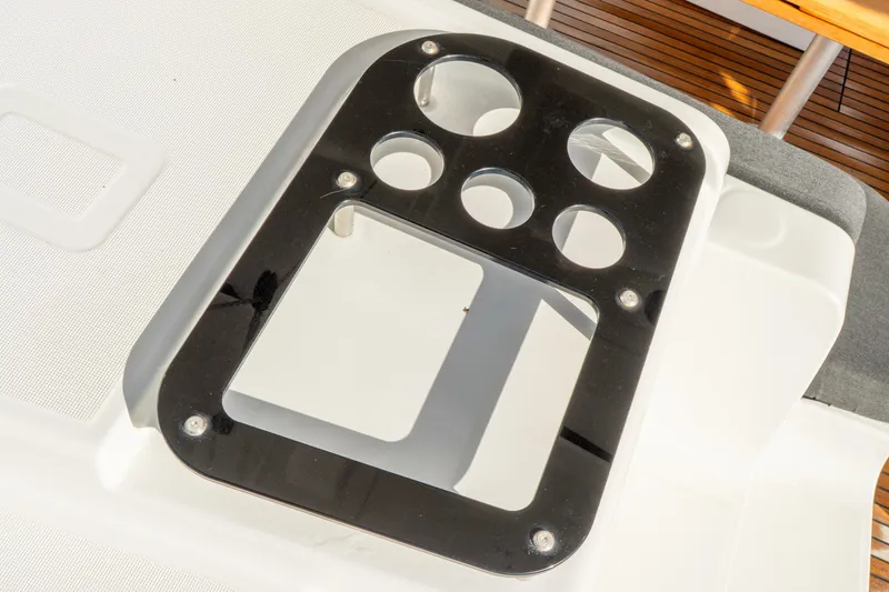 Slide: The Image of Control panel on 2023 Lagoon 46 yacht, featuring multiple circular cutouts. - 112