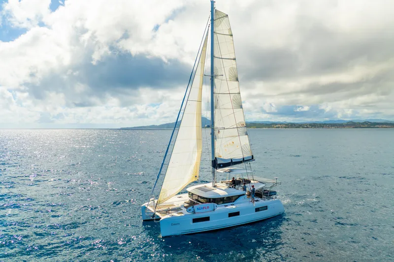 Slide: The Image of 2023 Lagoon 46 catamaran sailing on open sea under cloudy sky. - 134