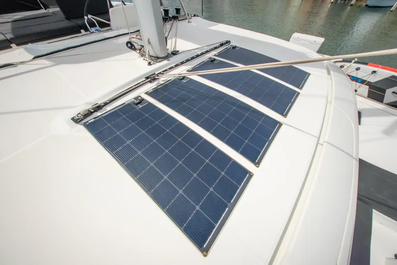 Slide: The Image of 2023 Lagoon 46 yacht with solar panels on deck, docked at marina. - 22