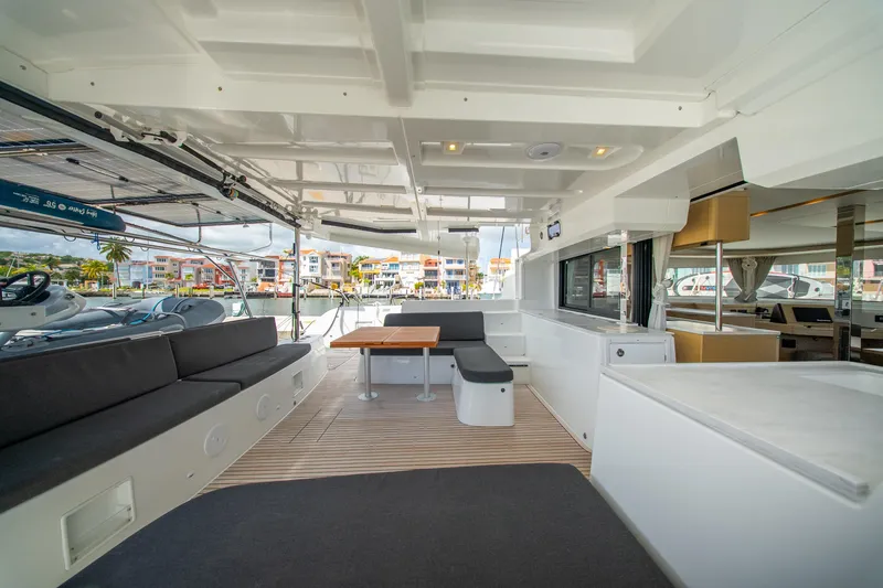 Slide: The Image of Spacious interior of 2023 Lagoon 46 catamaran with modern seating and dining area. - 27