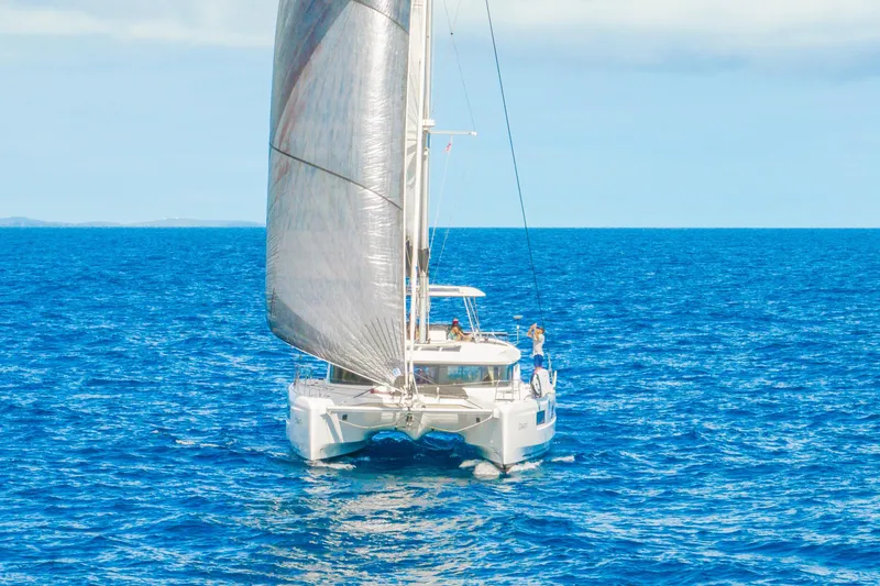 Slide: The Image of 2023 Lagoon 46 catamaran sailing on open blue ocean. - 3