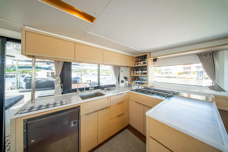 Slide: The Image of Modern kitchen interior of 2023 Lagoon 46 yacht with sleek cabinetry and large windows. - 32
