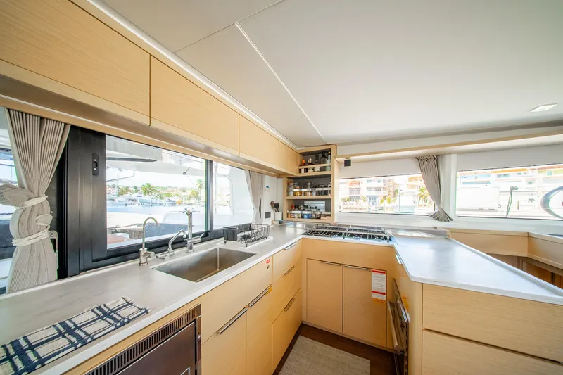 Slide: The Image of Modern kitchen interior of 2023 Lagoon 46 catamaran with sleek cabinetry and large windows. - 34
