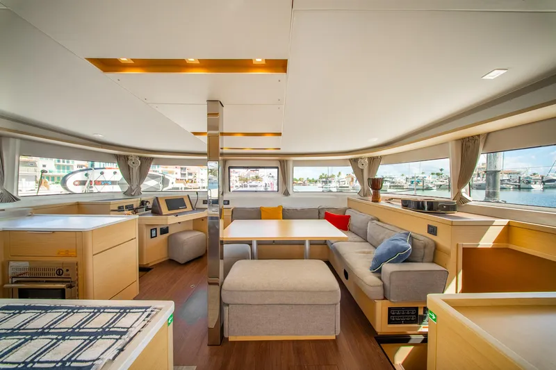 Slide: The Image of Luxurious interior of 2023 Lagoon 46 catamaran with modern furnishings and panoramic windows. - 37