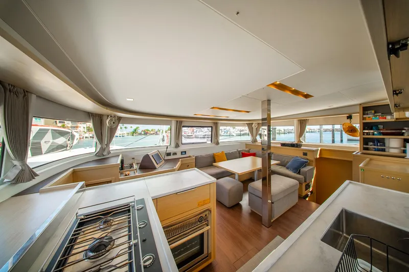 Slide: The Image of Luxurious interior of 2023 Lagoon 46 yacht, featuring modern kitchen and spacious seating area. - 39