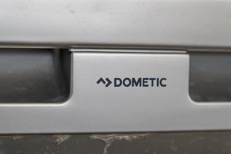 Slide: The Image of Close-up of Dometic logo on a 2023 Lagoon 46 yacht appliance. - 43
