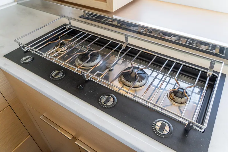 Slide: The Image of Modern gas stove with four burners on a 2023 Lagoon 46 yacht. - 48