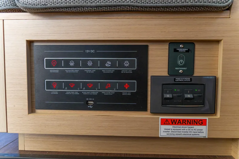 Slide: The Image of Control panel of 2023 Lagoon 46 yacht with electrical system switches and warning label. - 51