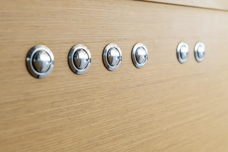 Slide: The Image of Close-up of chrome fixtures on 2023 Lagoon 46 yacht's wooden interior. - 52