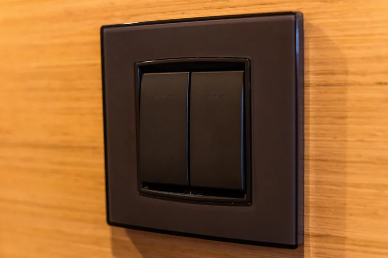 Slide: The Image of Black light switch on wooden panel, Lagoon 46 yacht, 2023 model. - 62