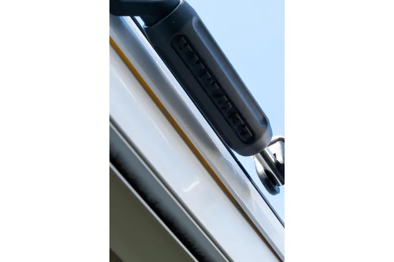 Slide: The Image of Close-up of a 2023 Lagoon 46 boat detail against a clear blue sky. - 65