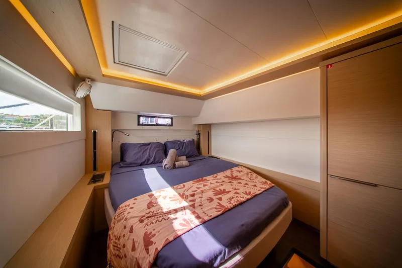 Slide: The Image of Luxurious cabin interior of 2023 Lagoon 46 yacht with modern lighting and cozy bedding. - 74