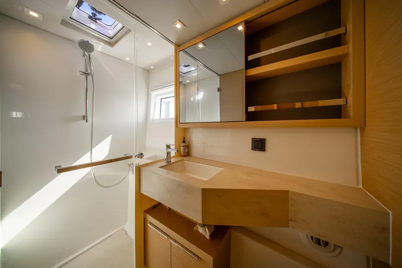 Slide: The Image of Modern bathroom interior of 2023 Lagoon 46 yacht with shower and wooden cabinetry. - 75