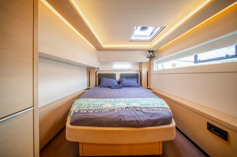 Slide: The Image of Luxurious cabin interior of 2023 Lagoon 46 yacht with modern design and cozy bedding. - 81