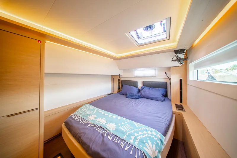 Slide: The Image of Luxurious interior of 2023 Lagoon 46 yacht cabin with skylight and modern design. - 82
